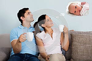 Couple Dreaming Of Having Child Together At Home photo