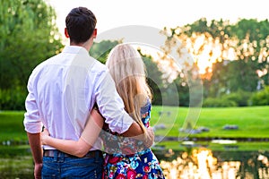 Couple dreaming their life together looking in sunset