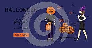 Couple dressed in halloween holiday outfit shopping with cartwit photo