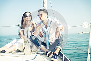 Couple drink champagne on a boat