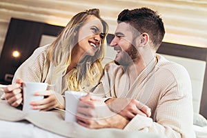 Couple drink coffee in luxury hotel room