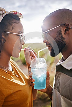 Couple, drink and date with a black woman and man drinking a beverage while outdoor in nature during summer. Dating