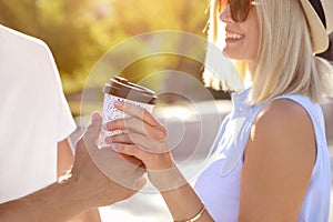 Couple with drink outdoors on summer day, closeup