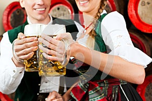 Couple drinking beer in brewery