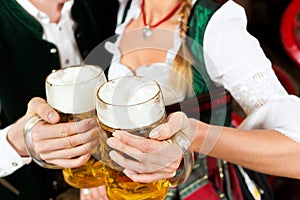 Couple drinking beer in brewery