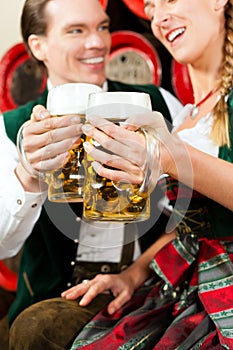 Couple drinking beer in brewery