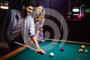 Couple drinking beer and playing snooker on date