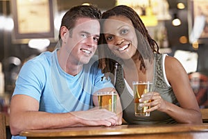 Couple Drinking Beer In A Pub