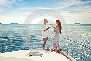 Couple drinking champagne on luxury yacht, sea holidays