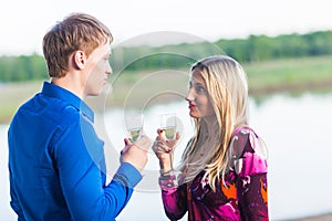 Couple drinking champagne outdoors enjoying their summer holidays.