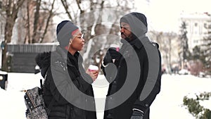 Couple drinking coffee and exploring city on winter day