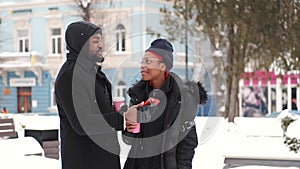 Couple drinking coffee and exploring city on winter day