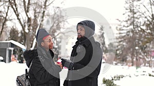 Couple drinking coffee and exploring city on winter day