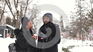 Couple drinking coffee and exploring city on winter day