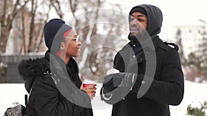 Couple drinking coffee and exploring city on winter day