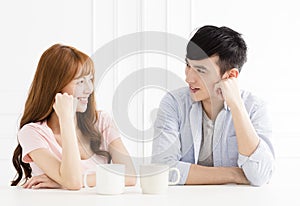 Couple drinking coffee in living room