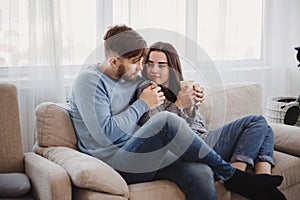 Couple drinking coffee in living room