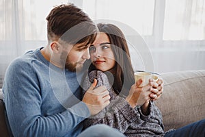 Couple drinking coffee in living room