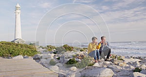 Couple drinking coffee by the sea