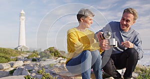 Couple drinking coffee by the sea