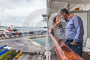 Couple drinking a drink on the deck of a cruise ship