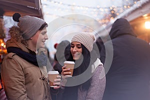 Couple drinking hot beverages at winter