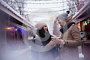 Couple drinking hot beverages at winter