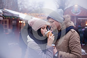 Couple drinking hot beverages at winter