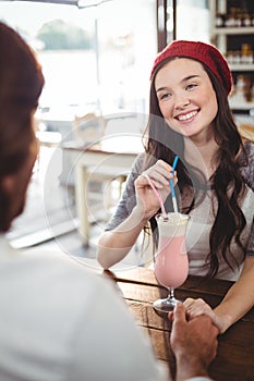 Couple drinking milkshake with a straw