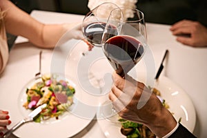 Couple drinking red wine at dinner in restaurant