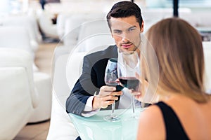 Couple drinking red wine in restaurant