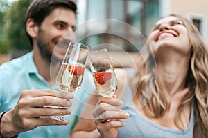 Couple drinking sparkling wine with strawberries