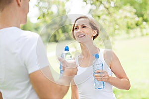 Couple drinking water after exercise
