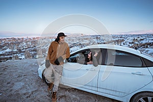 couple driving a car in cappadocia beautiful snowy landscape