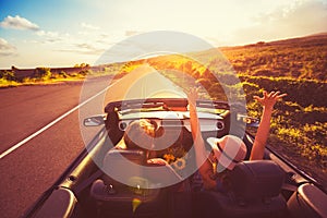 Couple Driving Convertable at Sunset