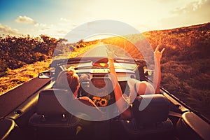 Couple Driving Convertable at Sunset