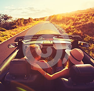 Couple Driving Convertable at Sunset photo