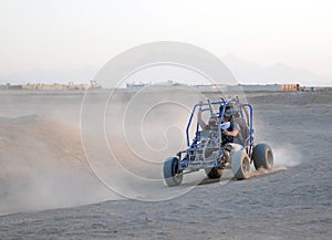 Couple driving Dune Buggy