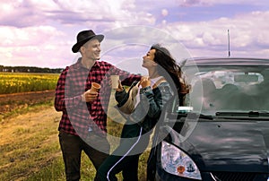 Travel, love, date and people concept - happy couple hugging relaxing with coffee on the road.