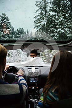 Couple driving in modern car at winter forest