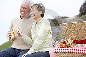 Couple Eating An Al Fresco Meal At The Beach