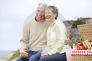 Couple Eating An Al Fresco Meal At The Beach