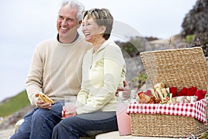 Couple Eating An Al Fresco Meal At The Beach