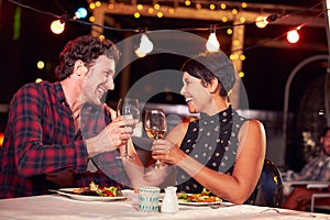 Couple eating dinner at rooftop restuarant