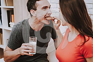 Couple is Eating and Drinking on Couch