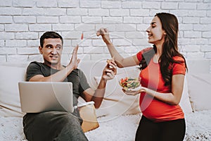 Couple is Eating and Drinking on Couch