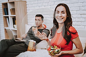 Couple is Eating and Drinking on Couch