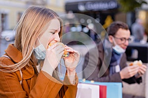 Couple eating fast food outdoors during shutdown photo