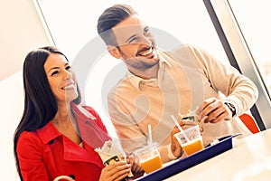 Couple eating in fast food restaurant