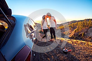 Couple eating having picnic near the car